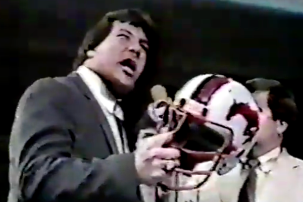 Ted DiBiase carrying Jim Duggan's football helmet