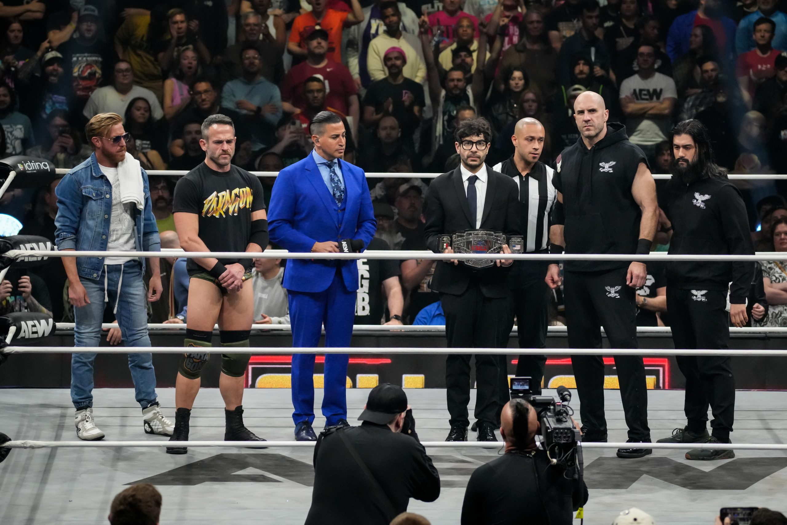 Tony Khan doing the ceremonial photo with the CMLL Heavyweight Championship